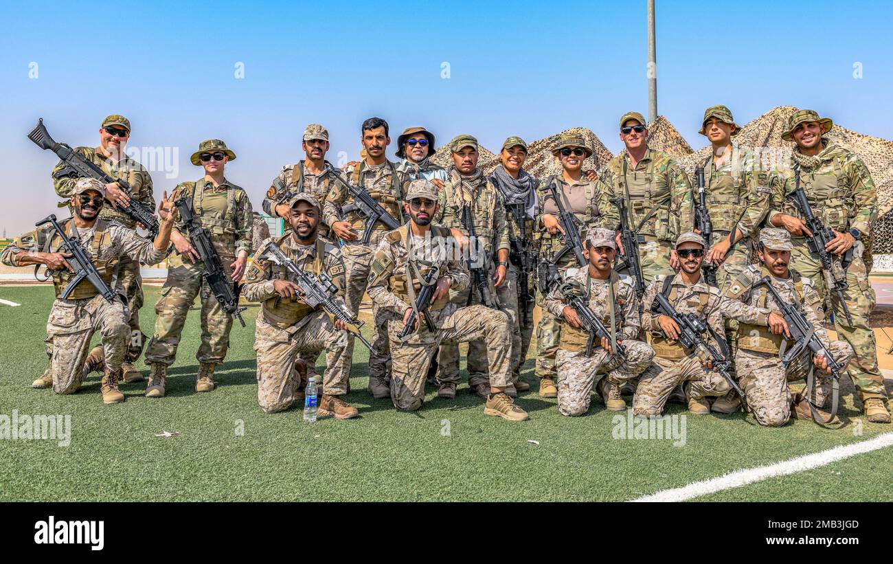 U.S. Airmen assigned to the 378th Expeditionary Security Forces Squadron, pose for a photo with a U.S. Army translator and Royal Saudi Land Force soldiers, in Al-Kharj, Kingdom of Saudi Arabia, June 10, 2022. Eight USAF Defenders were invited by the U.S. Army to attend Task Force Hurricane’s platoon immersion course alongside the Royal Saudi Land Force. The immersion allowed the 378th ESFS members a chance to develop as multi-capable Airmen by learning both Joint Force infantry tactics and Partner Nation infantry tactics not commonly taught or practiced by the USAF. Stock Photo