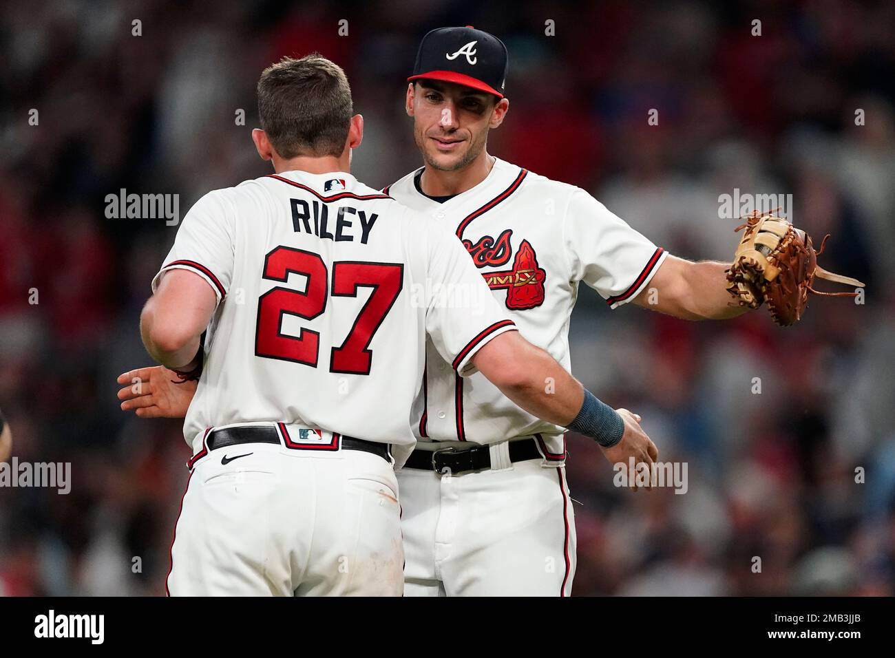 Atlanta Braves first baseman Matt Olson (28) and third baseman Austin Riley  (27) embrace after defeating