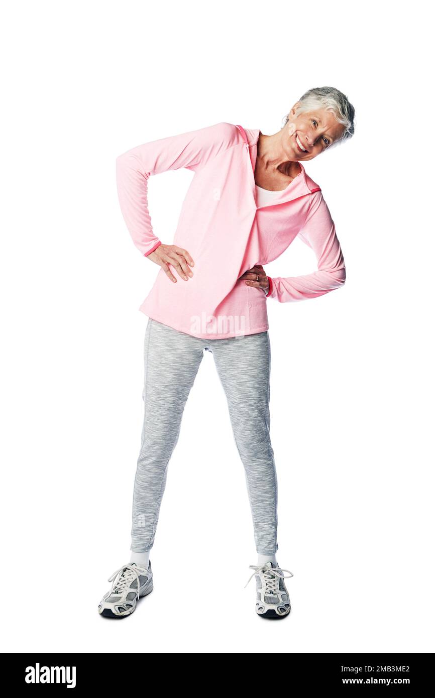 Exercise, fitness and senior woman portrait while stretching for health and wellness in studio. Body of happy and healthy female isolated on a white Stock Photo
