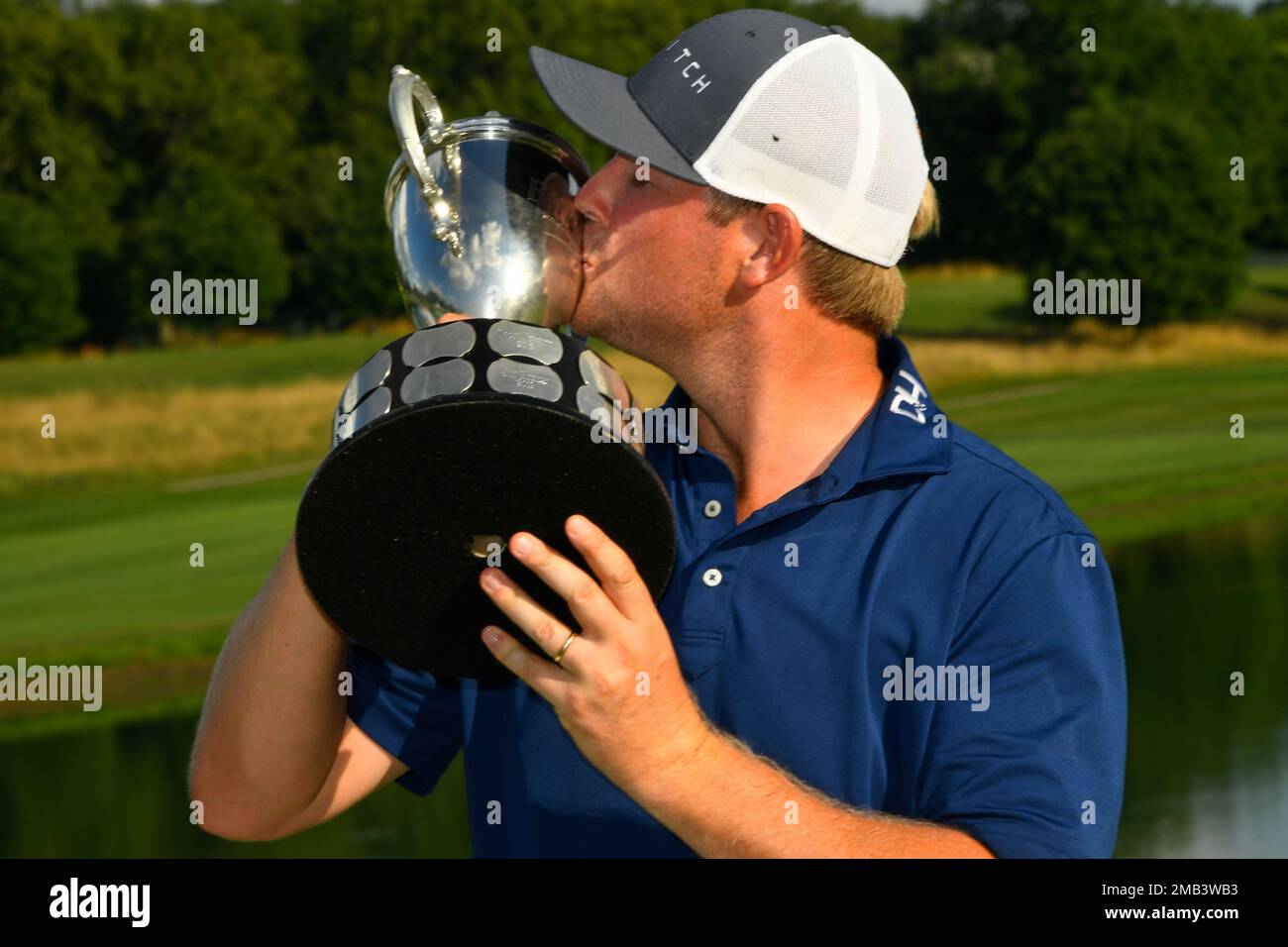 Trey Mullinax kisses the trophy after winning the Barbasol Championship