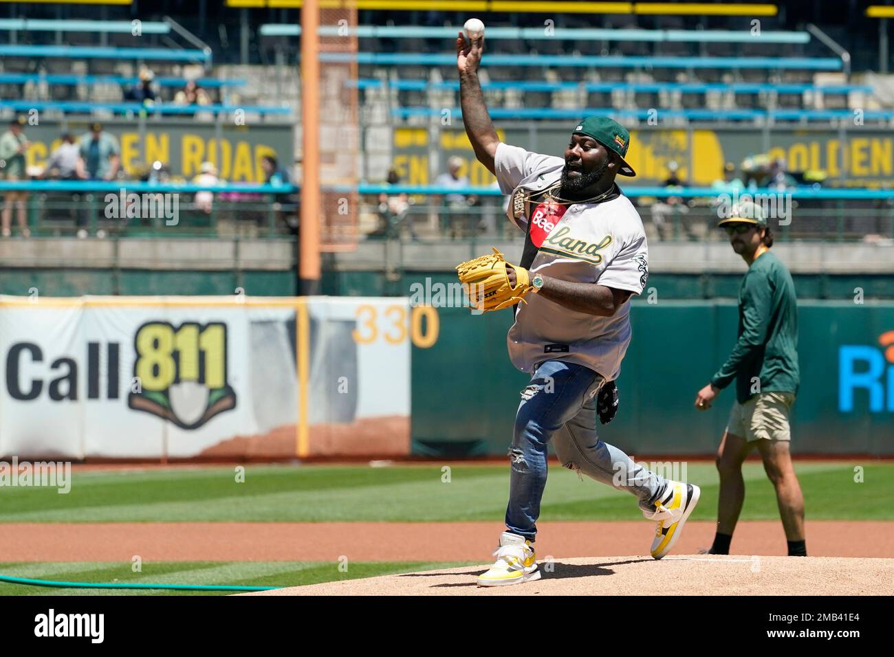 Oakland rapper Mistah F.A.B. throws the first pitch before a