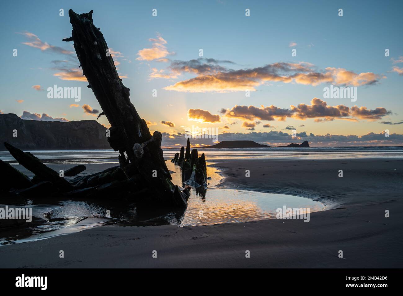 Wreck of the Helvetia, shipwreck on Rhossili beach at sunset, no people. Gower Peninsula, South Wales, the United Kingdom, UK GB. Stock Photo