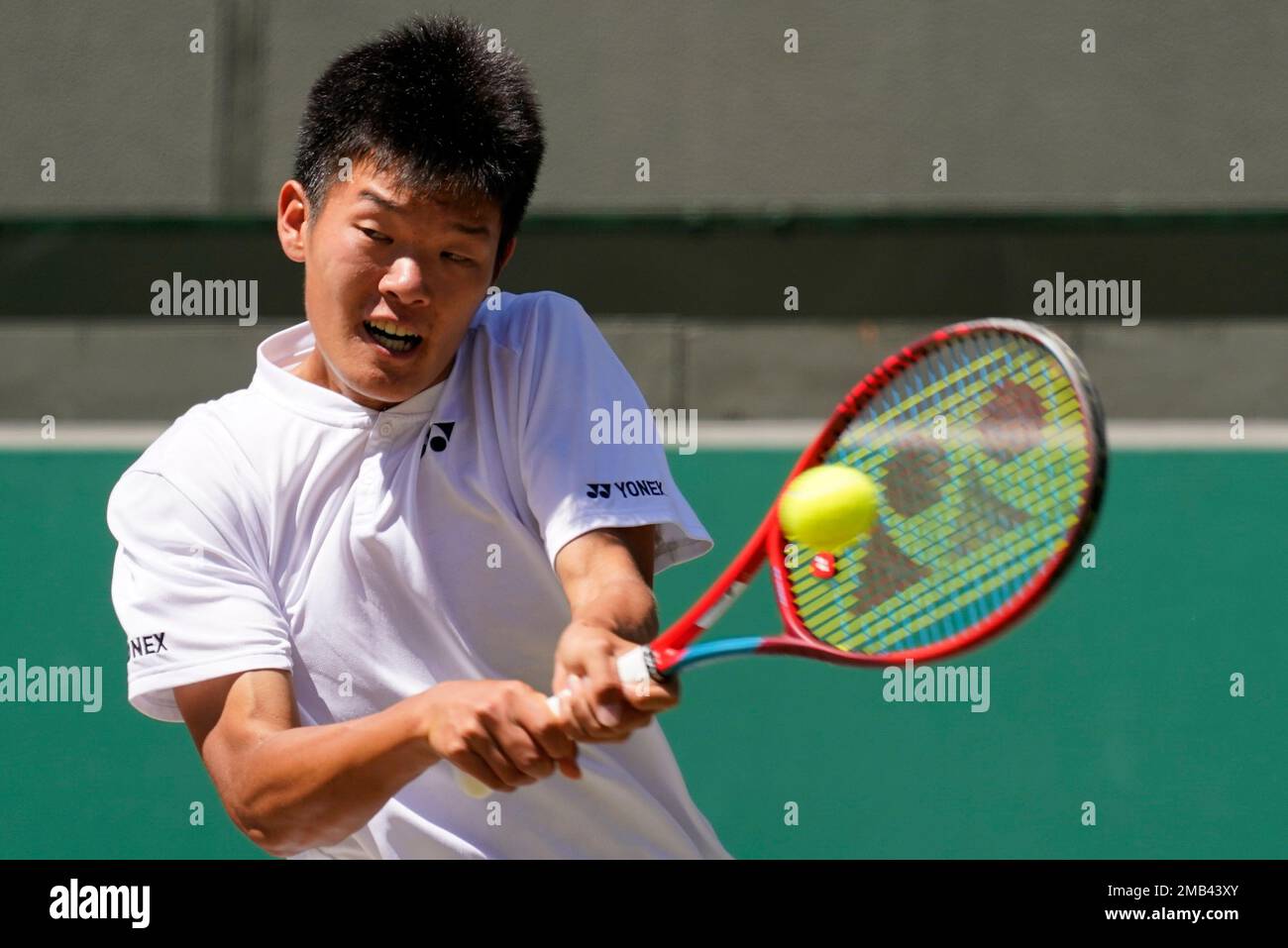 Michael Zheng of the United States returns to Croatias Mili Poljicak in the final of the boys singles on day fourteen of the Wimbledon tennis championships in London, Sunday, July 10, 2022