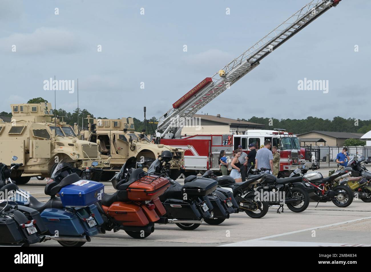 U.S. Air Force Airmen and their families attend a car show at Moody Air Force Base, Georgia, June 11, 2022. Eighty-eight cars, trucks, and motorcycles were displayed for the event where attendees had the opportunity to vote for their favorite vehicle. Stock Photo