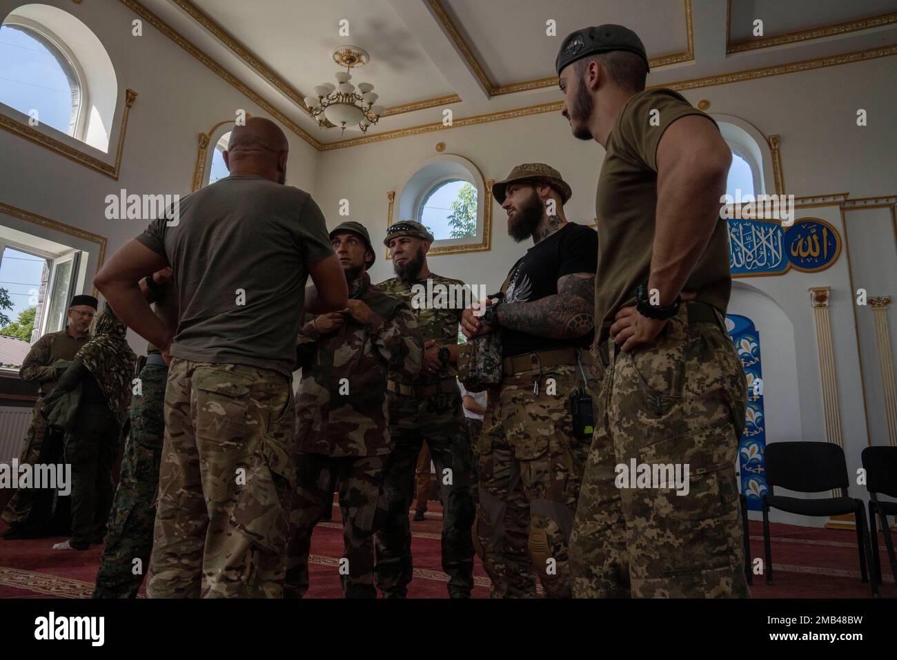 Ukrainian Muslim soldiers talk after prayers on the first day of Eid alAdha, in Medina Mosque
