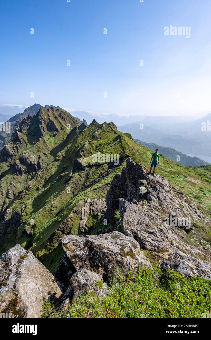 Pointed Ridge Hikers on rocks, Pointed green mountain peaks on the ridge of ...