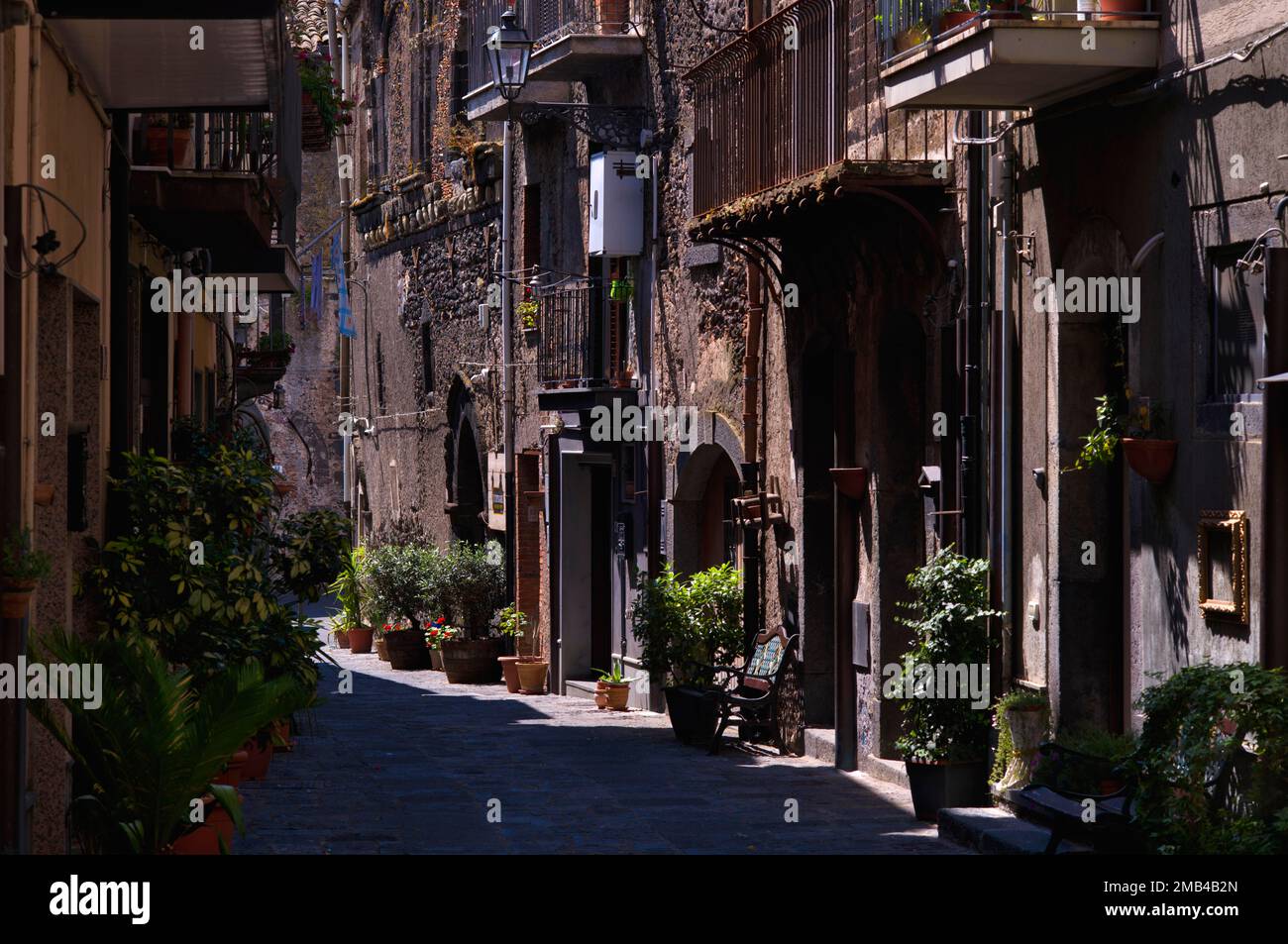 Volcanic stone houses, alley decorated with flowers, cobblestones, old town, Randazzo, Sicily, Italy Stock Photo