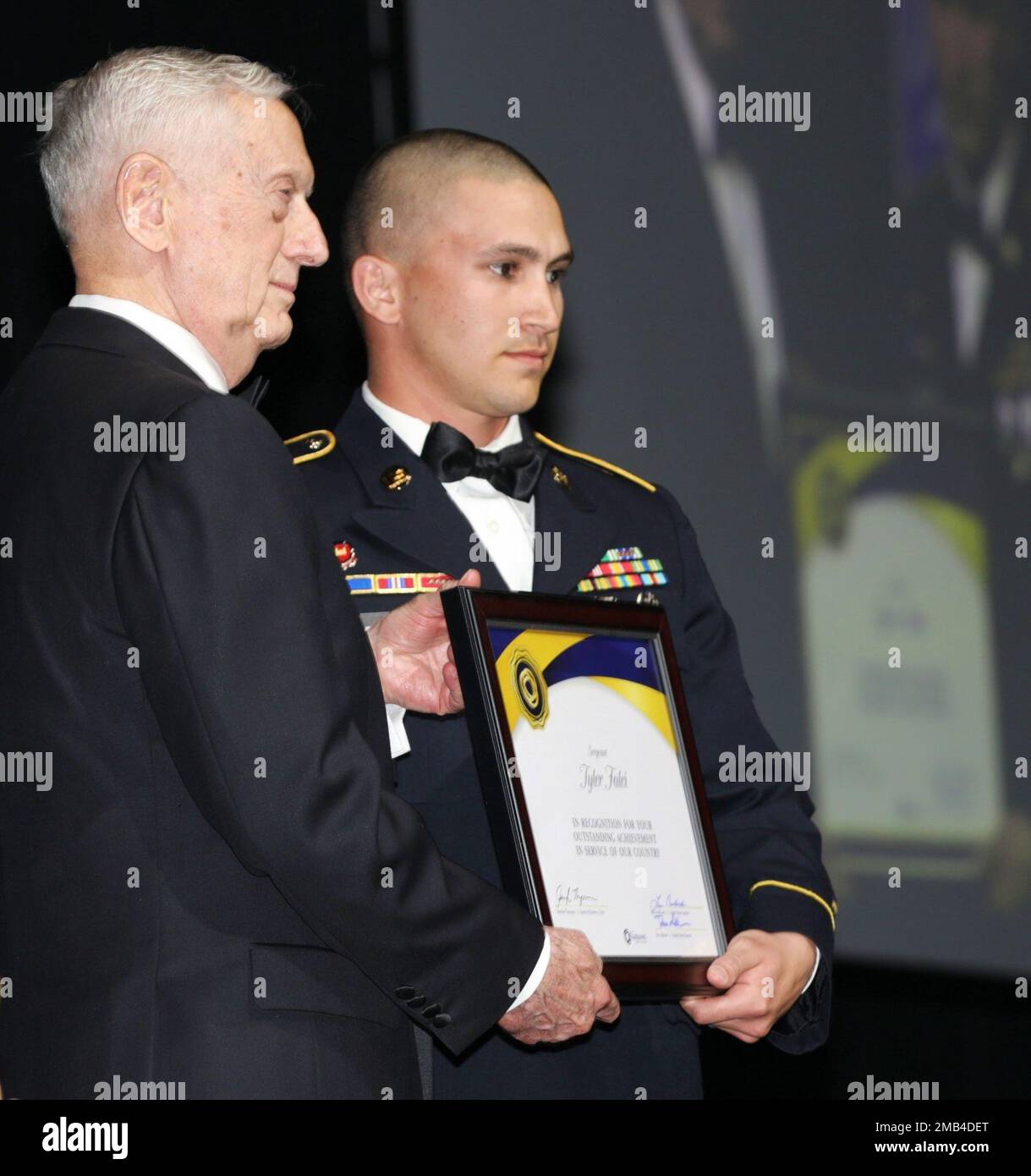 U.S. Army Sgt. Tyler Falci, right, of Bravo Company, 70th Brigade Engineer Battalion (BEB), 1st Infantry Brigade Combat Team, 11th AB Division, poses with former Secretary of Defense James Mattis, who led a star-studded lineup of military and community leaders thanking Alaska service members at the 52nd Annual Military Appreciation Banquet, June 11, 2022, at the Carlson Center in Fairbanks, Alaska. The Greater Fairbanks Chamber of Commerce event honored Falci and 12 other Soldiers and Airmen, both active duty and Guard, and two civilians for their exceptional achievements and volunteer efforts Stock Photo