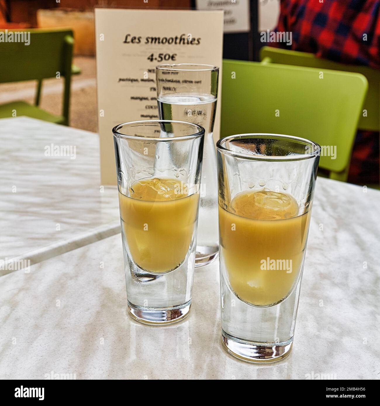 Two glasses of Pastis with ice on a table in the restaurant, Old Town, Roussillon, Vaucluse, Provence, South of France, France Stock Photo