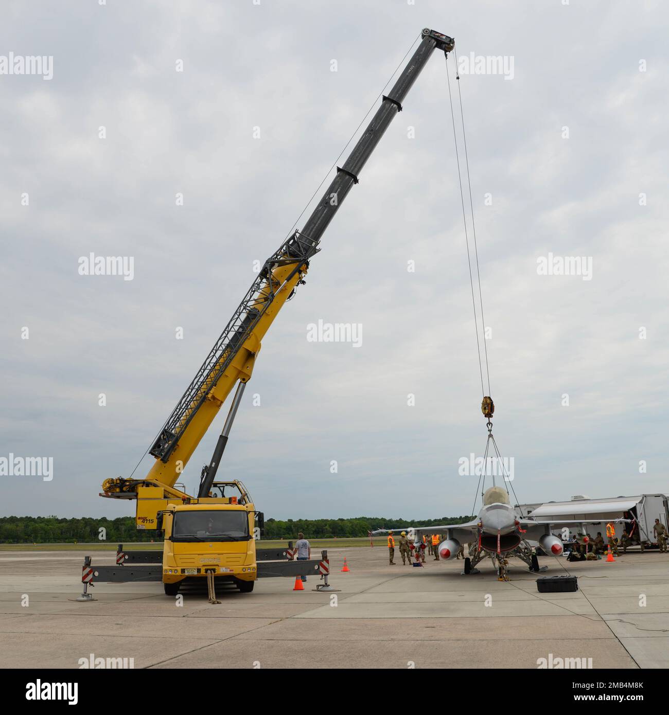 A F16D fighter jet is prepared to be lifted during a