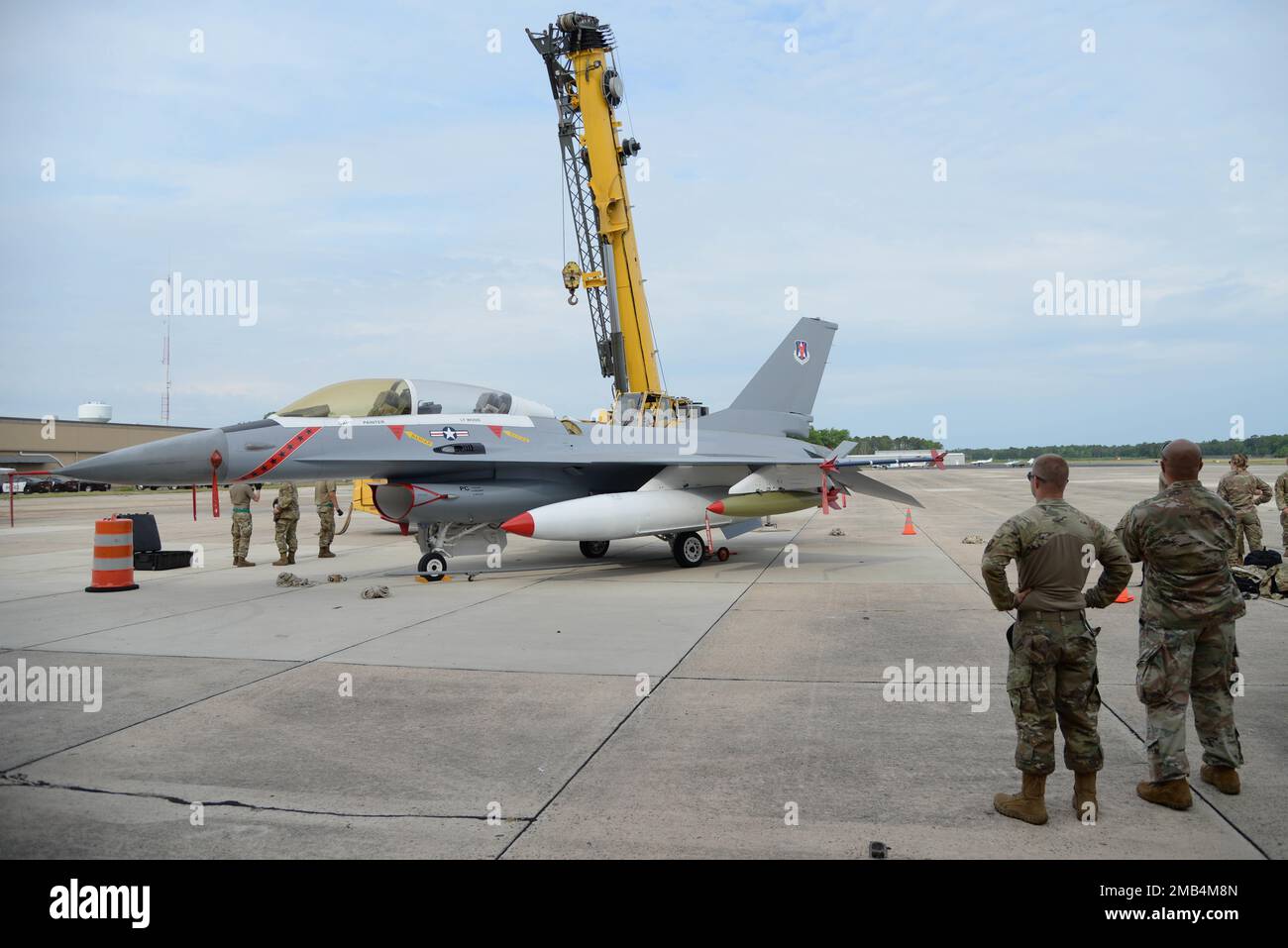 A F16D fighter jet is prepared to be lifted during a