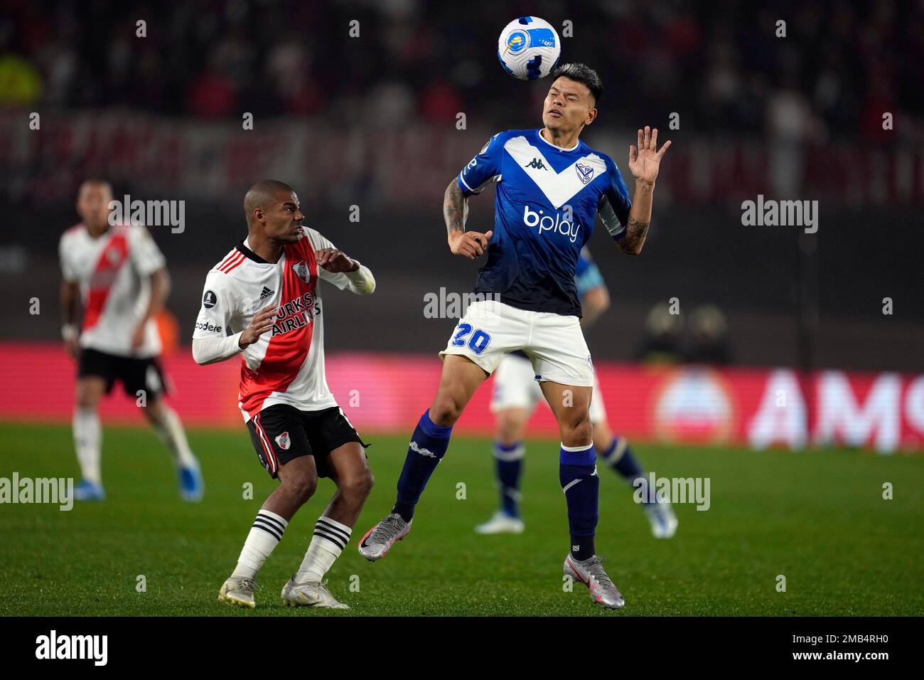 Nicolas De La Cruz of River Plate, left, looks as Walter Bou of Velez  Sarsfield heads the ball during a Copa Libertadores round of sixteen,  second leg soccer match at Monumental stadium