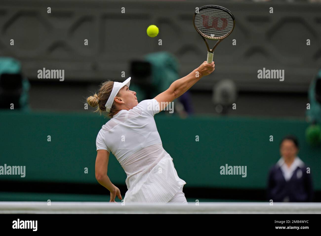 Romania's Simona Halep plays a backhand smash return to Amanda Anisimova of  the US in a women's singles quarterfinal match on day ten of the Wimbledon  tennis championships in London, Wednesday, July