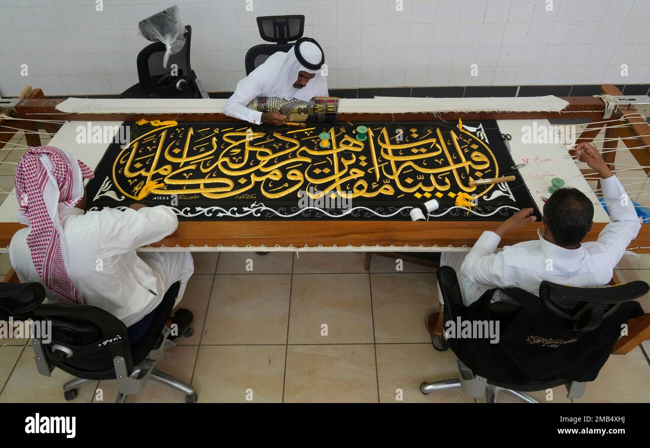Saudi workers embroider Islamic calligraphy, using either pure silver