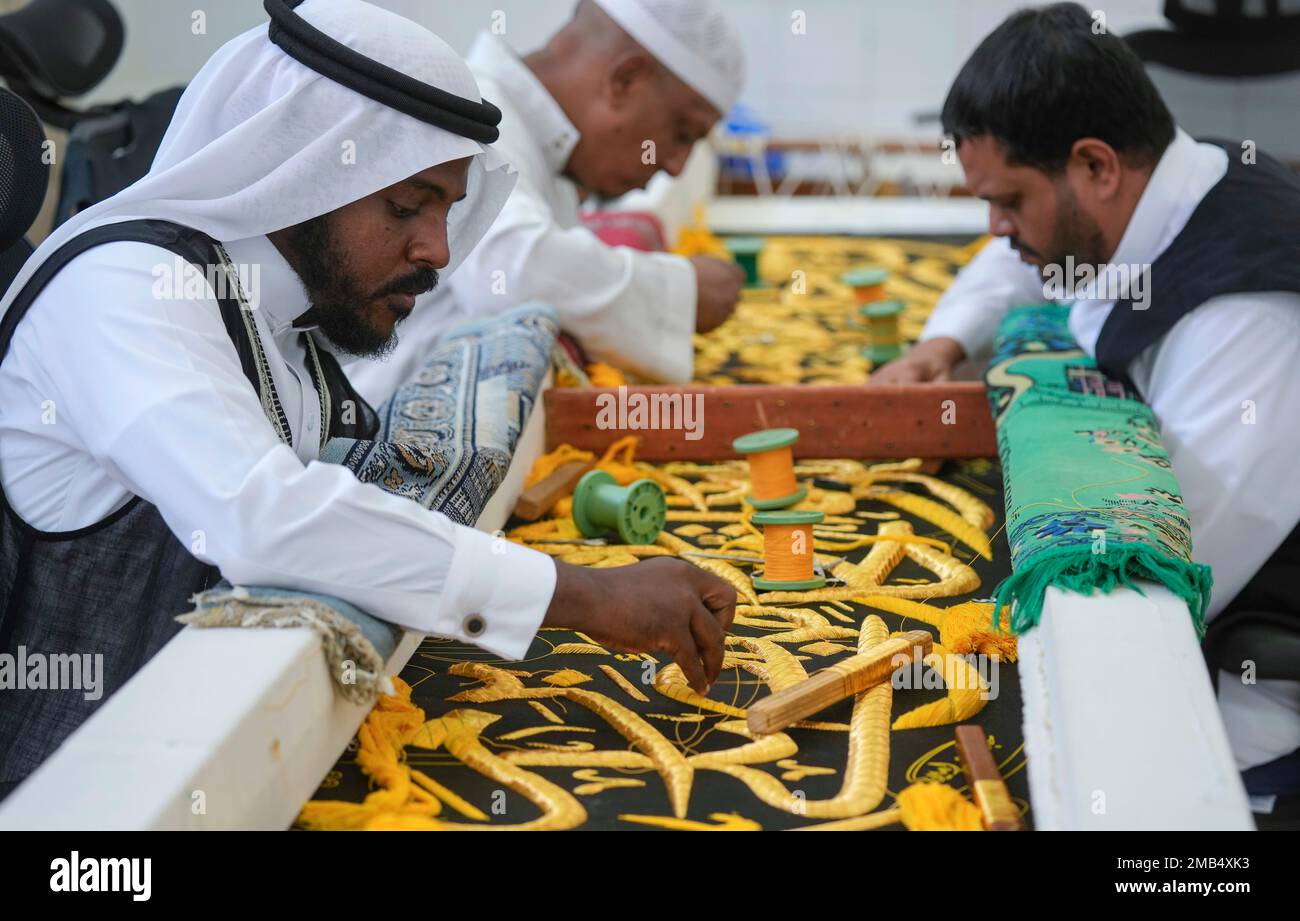 Saudi workers embroider Islamic calligraphy, using either pure silver
