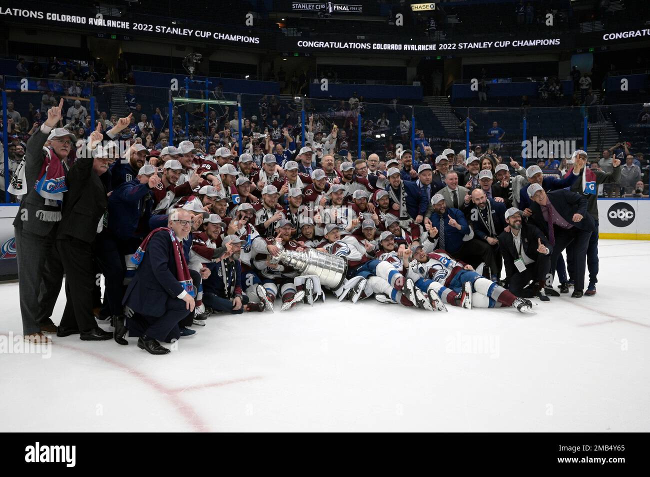 Colorado Avalanche team members pose with the Stanley Cup after