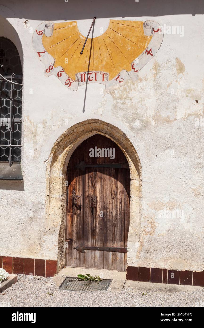 Sundial and wooden door at the church of St. Laurentius, RottachEgern