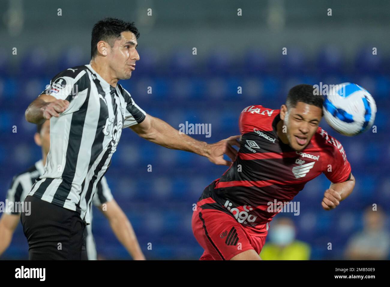 Ze Ivaldo of Brazil's Athletico Paranaense heads the ball in an attempt to  score as Diego Viera of Paraguay's Libertad challenges him during a Copa  Libertadores round of sixteen second leg soccer