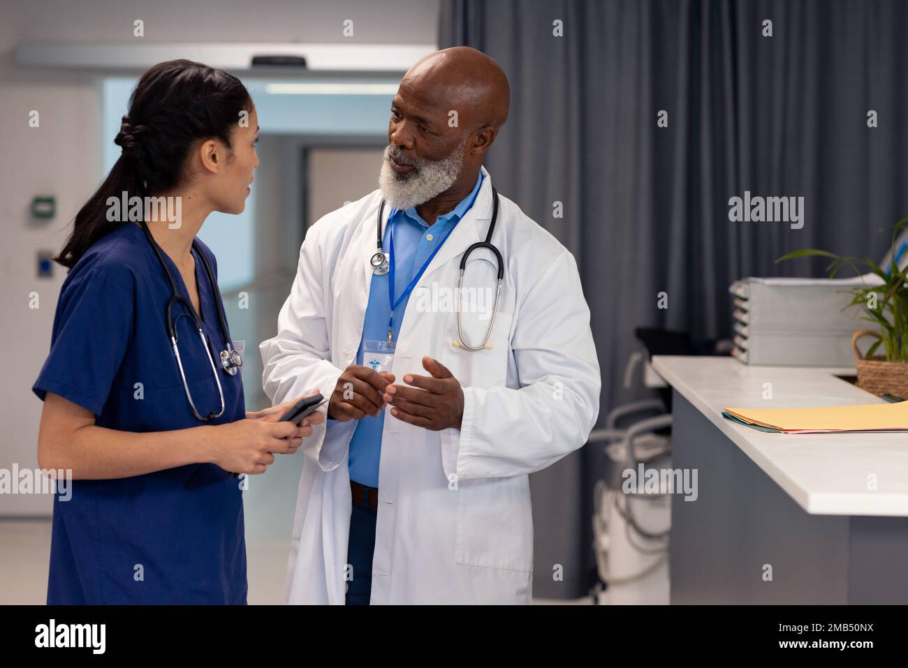 Diverse female doctor talking male hi-res stock photography and images ...