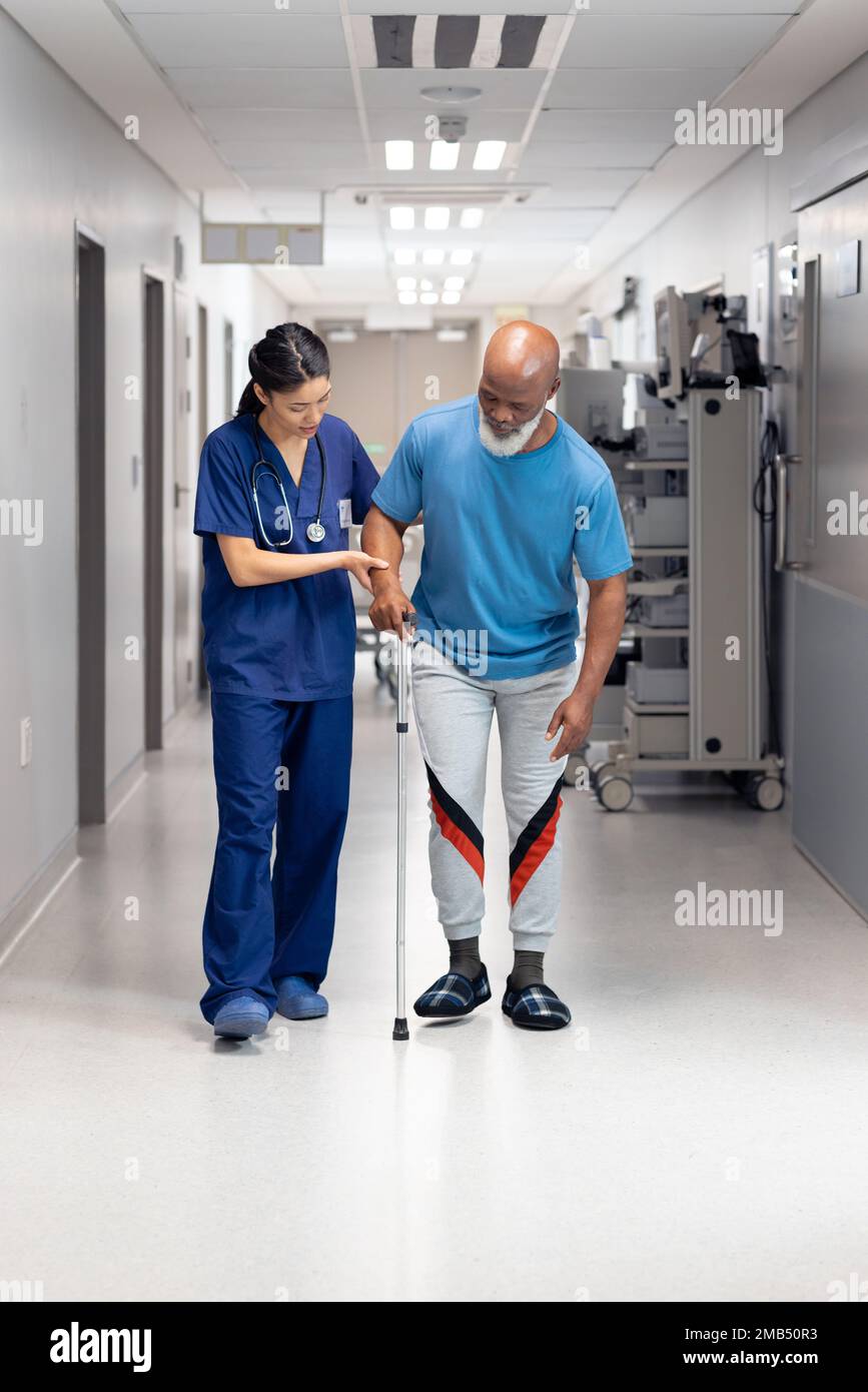 Vertical of diverse female doctor helping senior male patient use walking  stick, copy space Stock Photo - Alamy