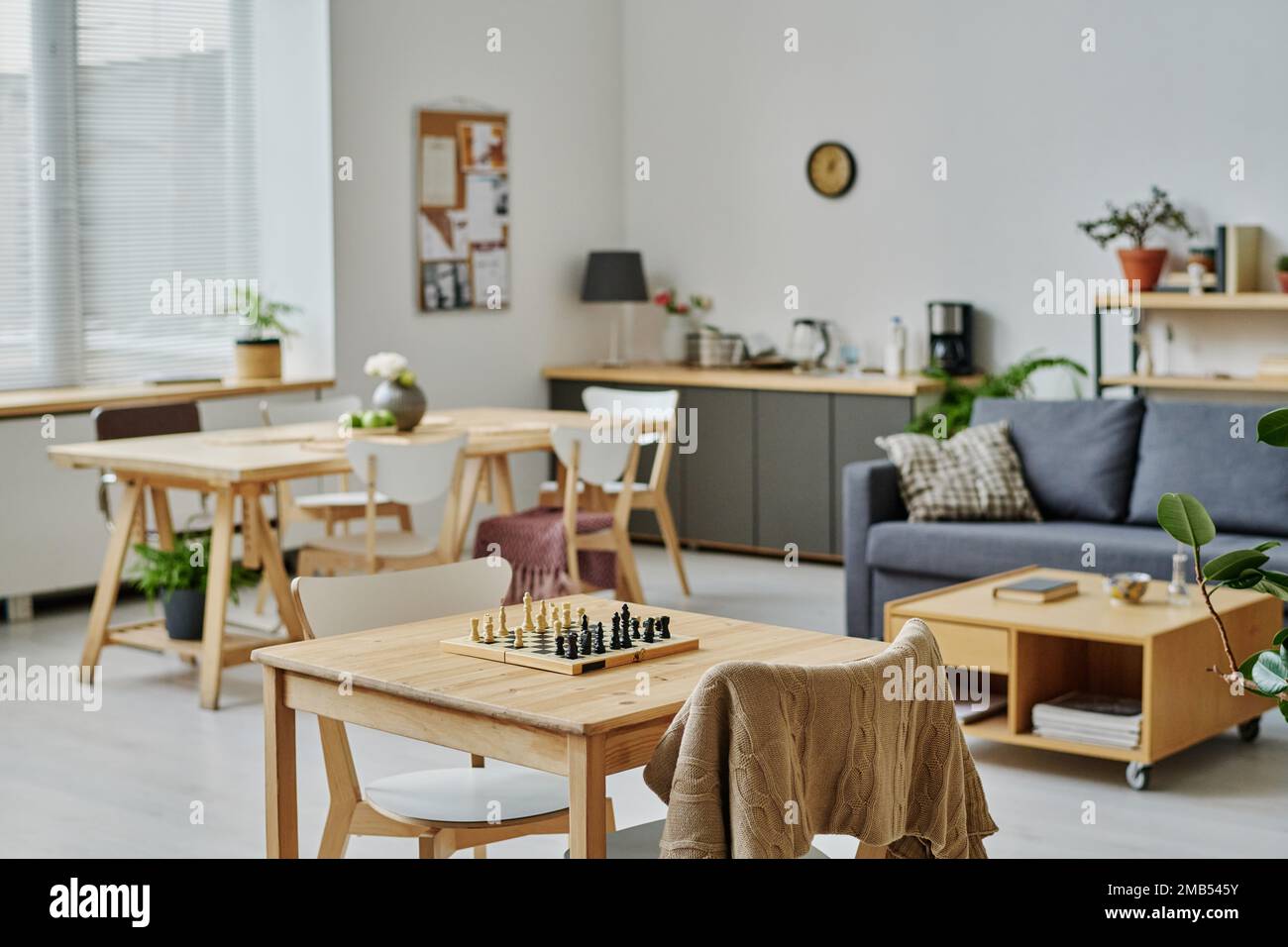 Horizontal image of modern room with sofa and table for board games in