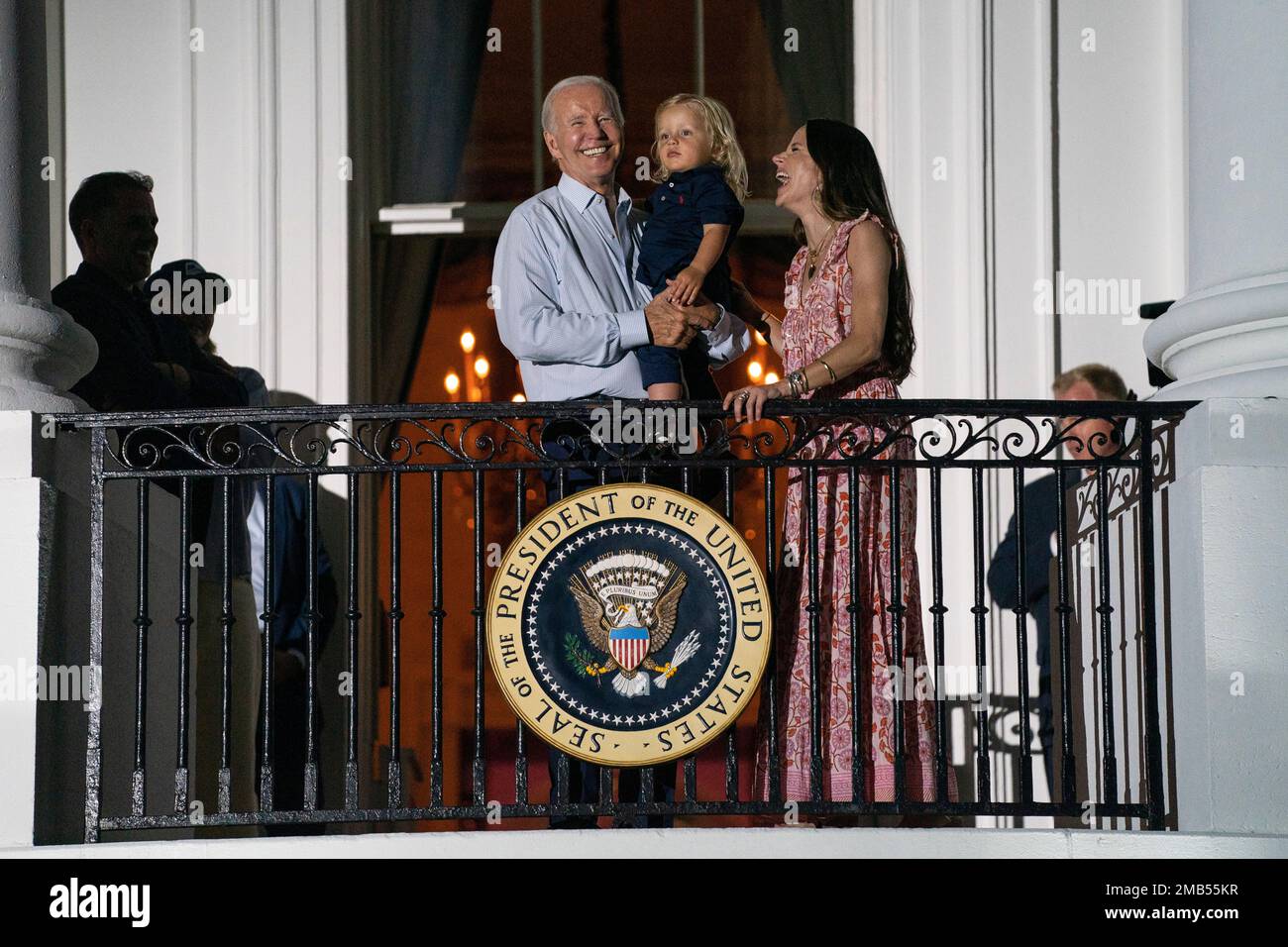President Joe Biden holds his grandson Beau Biden as he talks with his