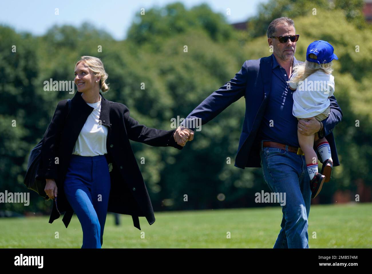 Melissa Cohen Biden walks with her husband Hunter Biden and their son Beau  as they arrive with President Joe Biden at Ft. McNair aboard Marine One  after spending the weekend at Camp