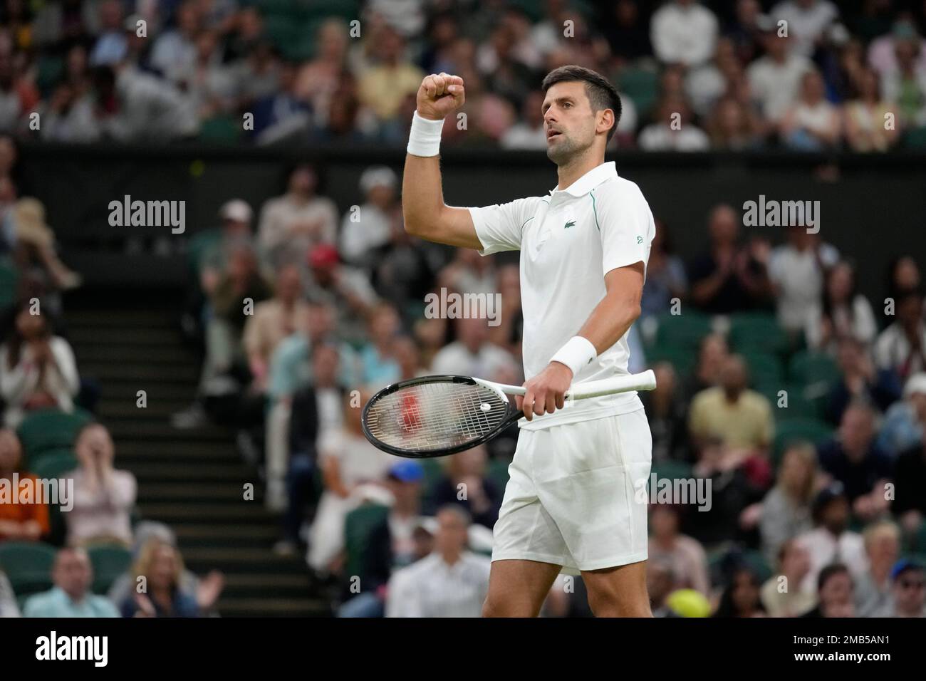 Serbias Novak Djokovic celebrates winning a point against Tim van Rijthoven of the Netherlands during a mens fourth round singles match on day seven of the Wimbledon tennis championships in London, Sunday,