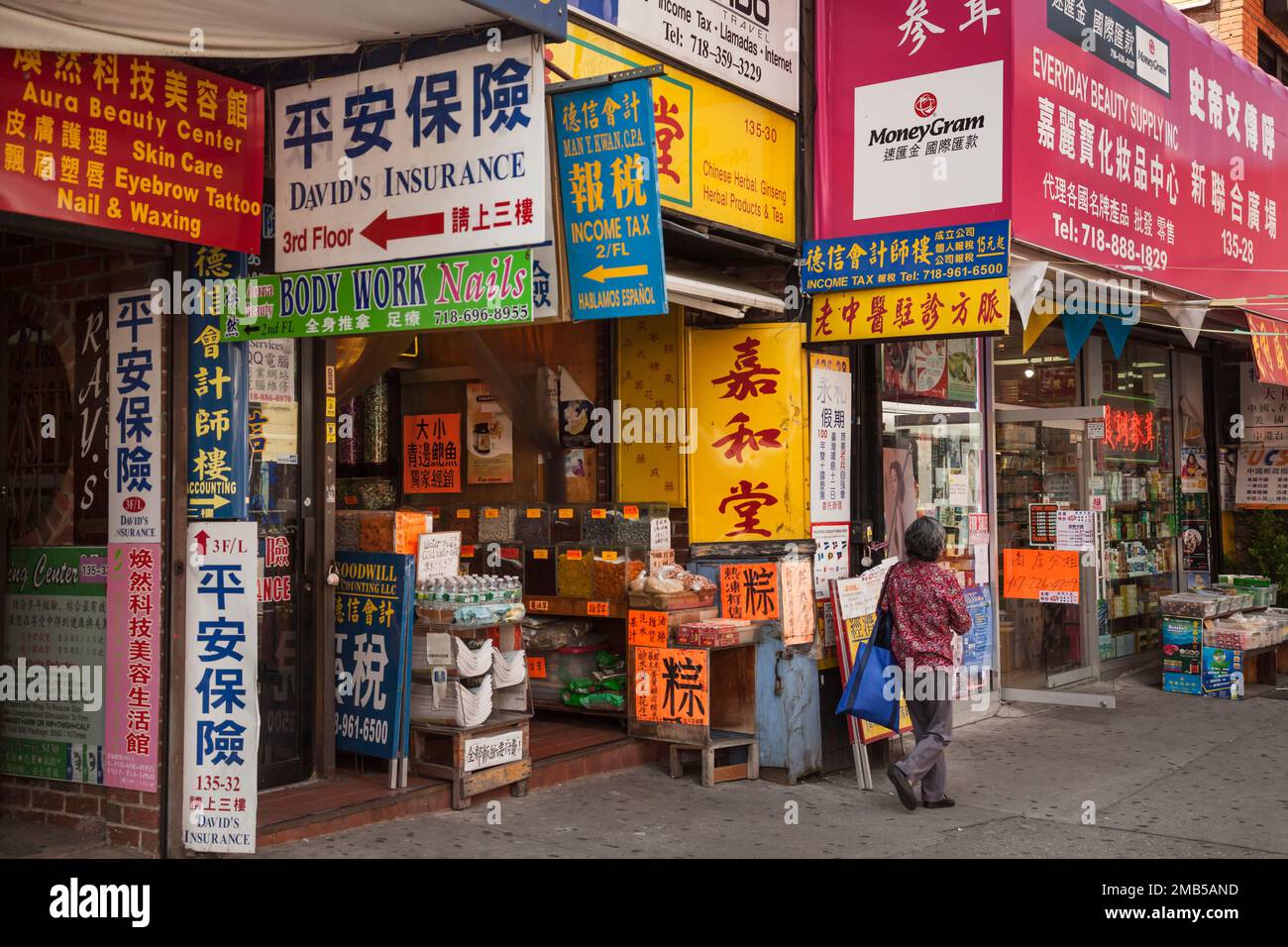 Street covered by Oriental signs in Flushing neighborhood, Queens, New