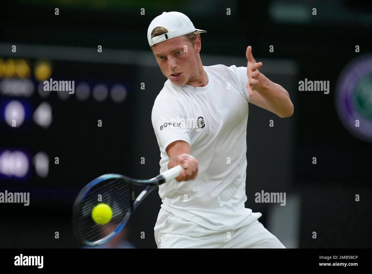 Tim van Rijthoven of the Netherlands returns the ball to Serbias Novak Djokovic during a mens fourth round singles match on day seven of the Wimbledon tennis championships in London, Sunday, July
