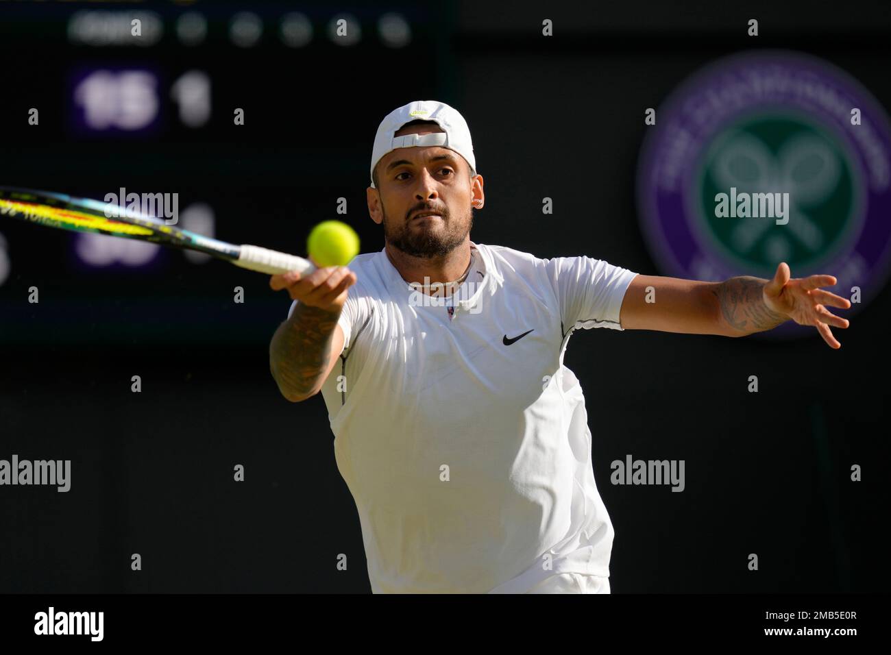 Australias Nick Kyrgios returns the ball to Greeces Stefanos Tsitsipas during a third round mens singles match on day six of the Wimbledon tennis championships in London, Saturday, July 2, 2022