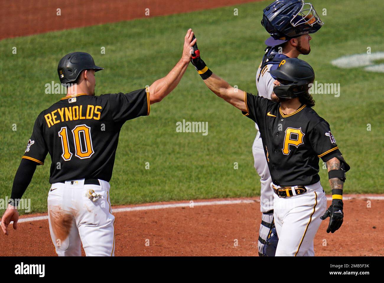 Pittsburgh Pirates' Michael Chavis, right, celebrates with Bryan Reynolds  (10) after hitting a two-run home run off Milwaukee Brewers starting  pitcher Aaron Ashby during the third inning of a baseball game in