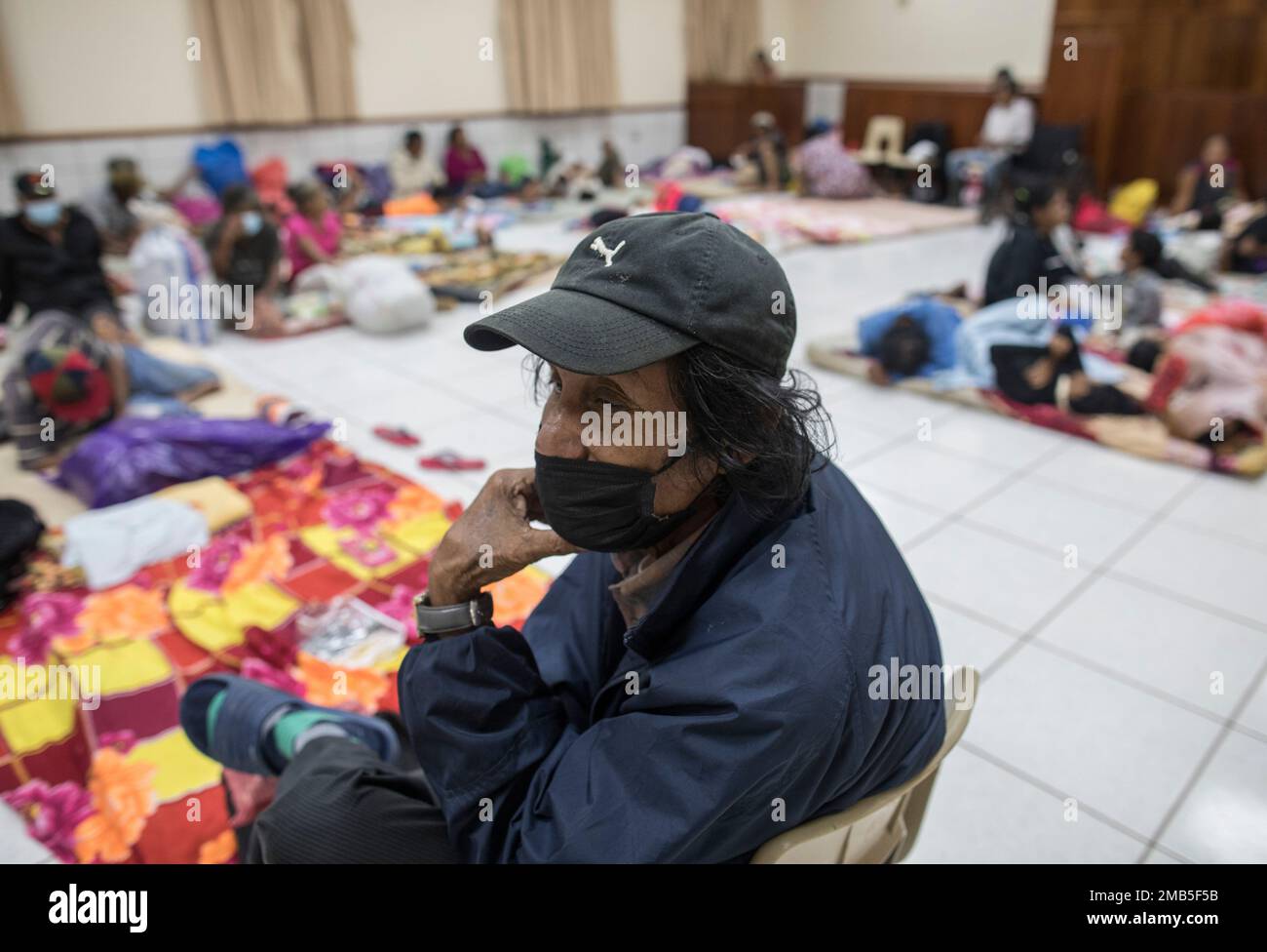 Residents of the Monkey Point community rest at a temporary shelter in