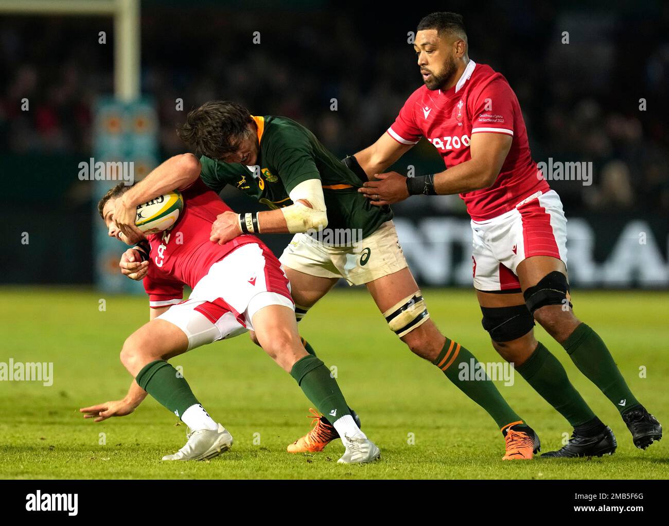 Wales Kieran Hardy, left, is challenged by South Africas Franco Mostert, center, during the Rugby Championship test at Loftus Versfeld Stadium in Pretoria, South Africa, Saturday, July 2, 2022