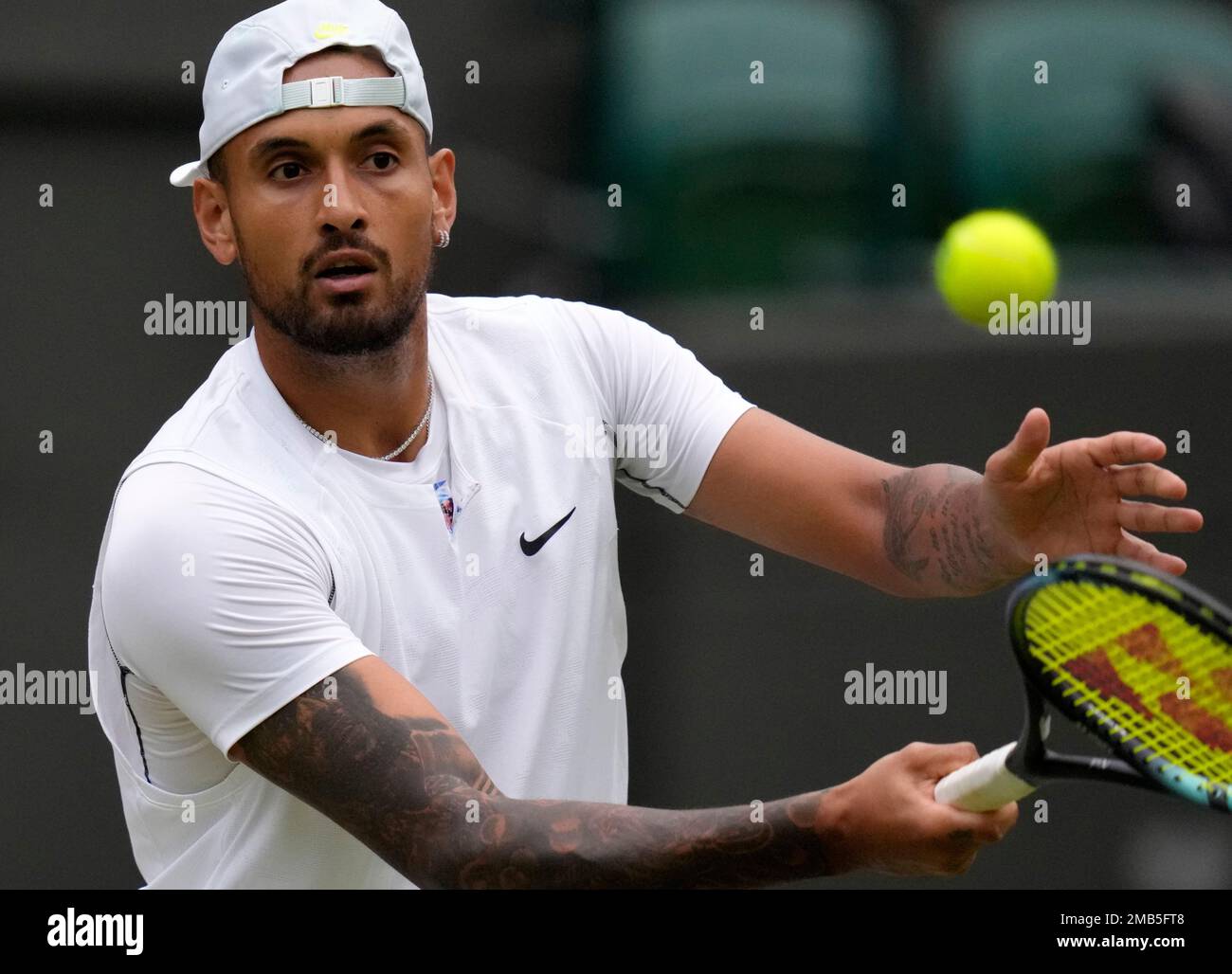 Australias Nick Kyrgios returns to Greeces Stefanos Tsitsipas during their third round mens singles match against on day six of the Wimbledon tennis championships in London, Saturday, July 2, 2022
