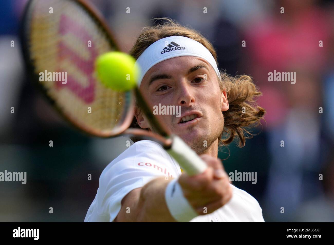Greeces Stefanos Tsitsipas returns the ball to Australias Nick Kyrgios during a third round mens singles match on day six of the Wimbledon tennis championships in London, Saturday, July 2, 2022