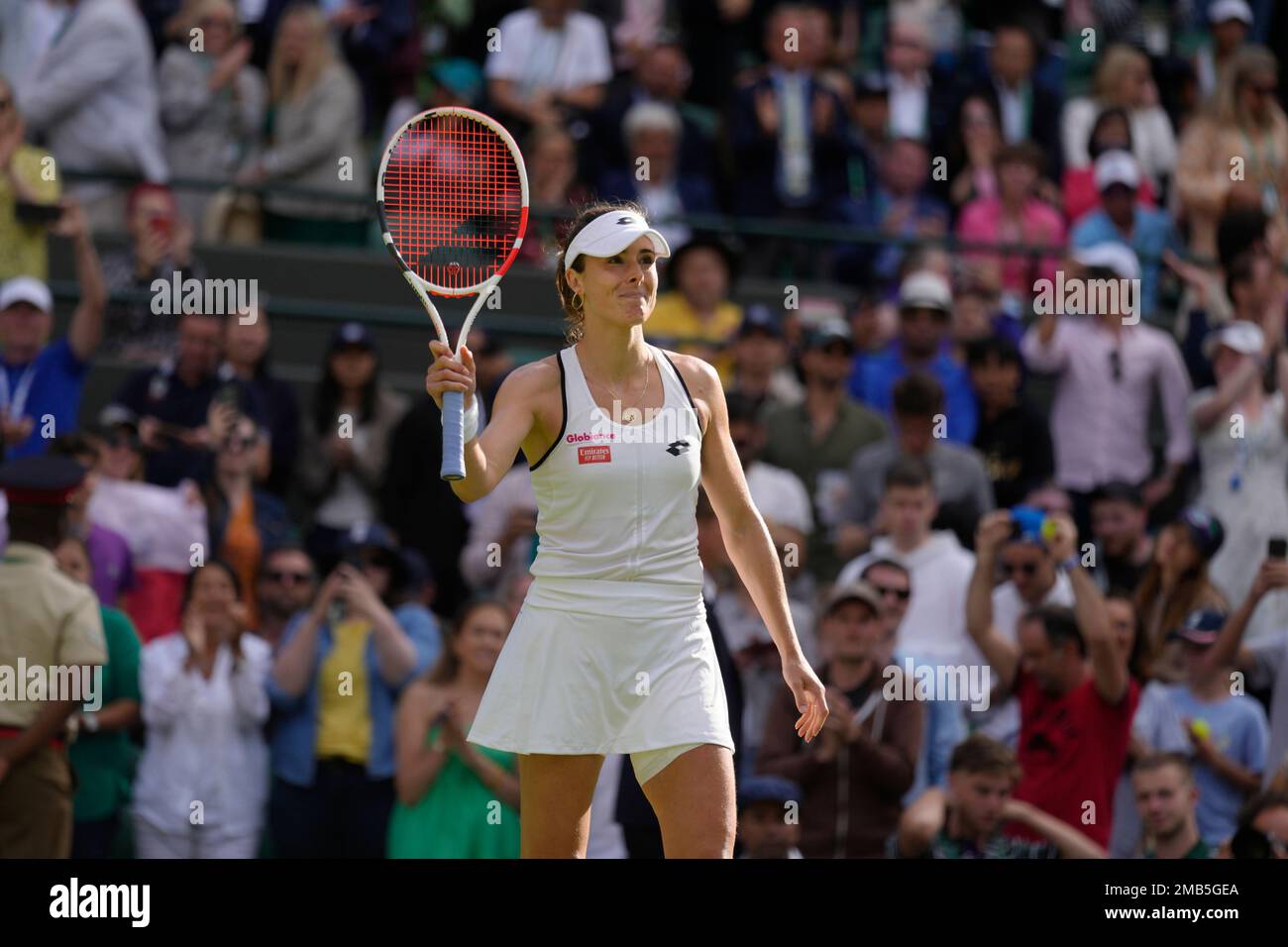 Alize Cornet of France celebrates beating Serena Williams of the