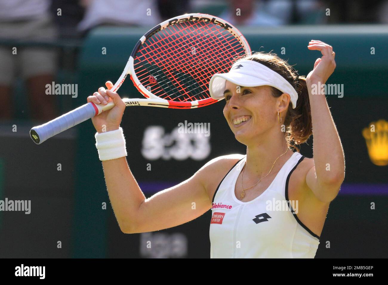 Alize Cornet of France celebrates beating Serena Williams of the