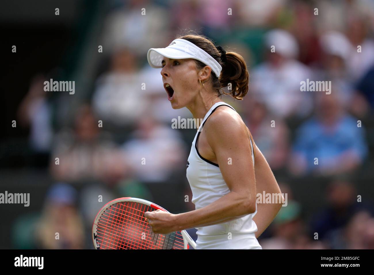 France's Alize celebrates winning the first set against Poland's Iga Swiatek during a