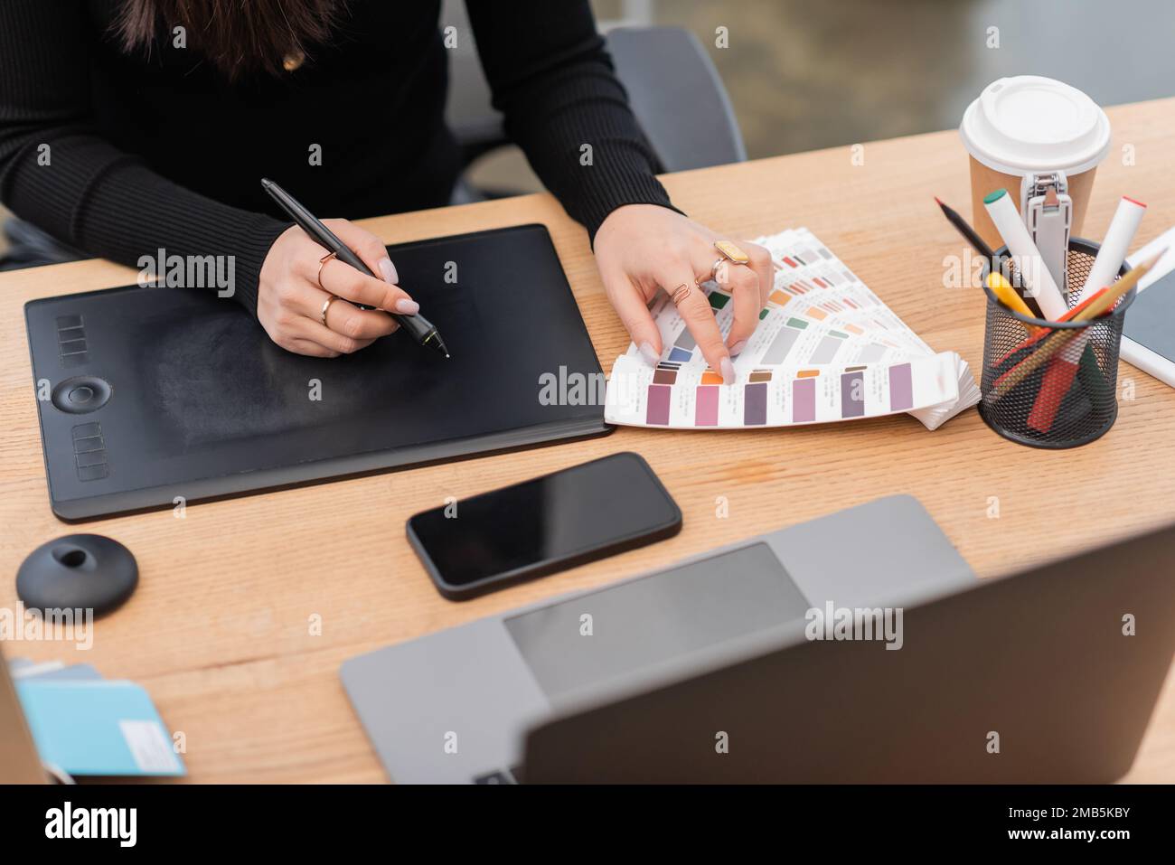 Cropped view of interior designer using color samples and graphic tablet in studio,stock image Stock Photo