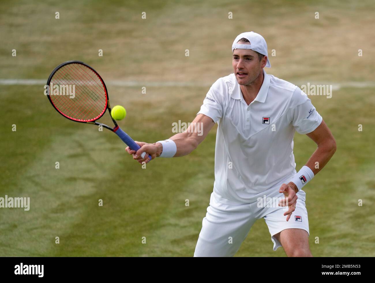 John Isner of the US returns to Italys Jannik Sinner during their mens singles third round match on day five of the Wimbledon tennis championships in London, Friday, July 1, 2022