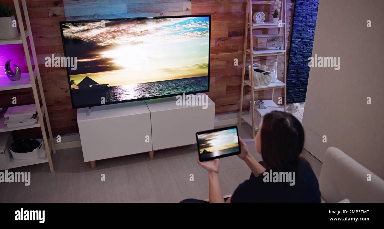 Woman Watching TV Through Tablet Television And Movie Streaming Stock