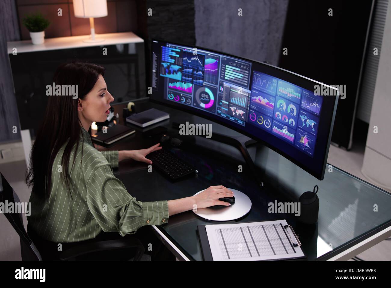 Business Woman Analyst Using KPI Data On Computer Stock Photo