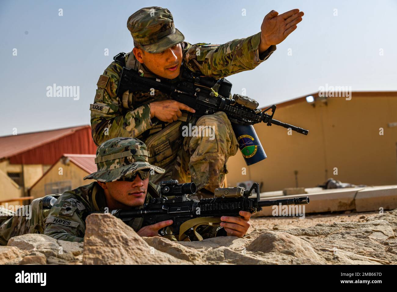 A U.S. Soldier assigned to Task Force Hurricane from the 1st Battalion, 124th Infantry Regiment, assigns his comrades a security area during a platoon immersion in Al-Kharj, Kingdom of Saudi Arabia, June 12, 2022. The immersion was a training event meant to build interoperability between the U.S Army and Royal Saudi Land Force at the platoon level while enhancing both U.S. and partner nation skillsets. Stock Photo
