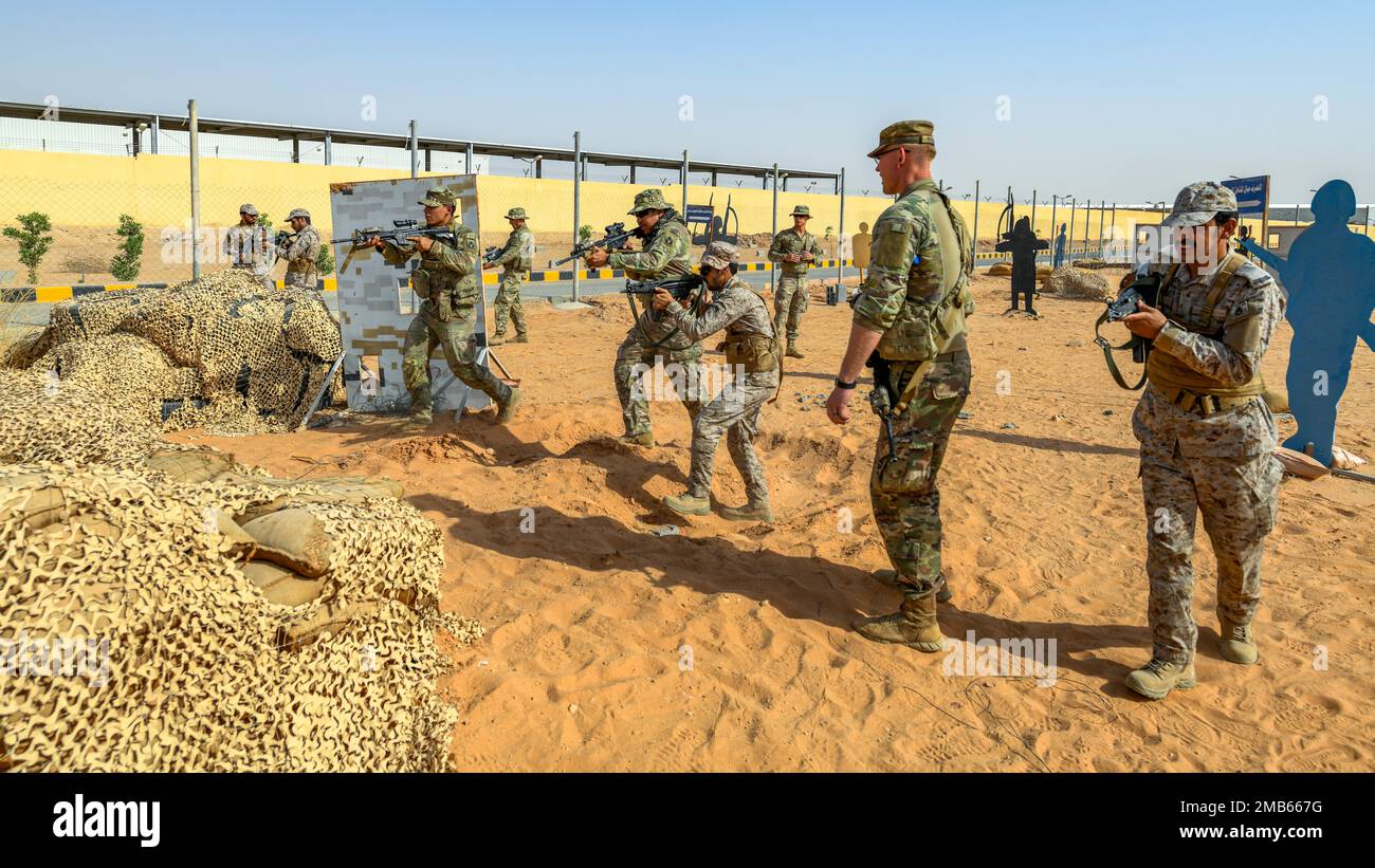 U.S. Soldiers assigned to Task Force Hurricane from the 1st Battalion, 124th Infantry Regiment, and Royal Saudi Land Force soldiers move in line during a platoon immersion in Al-Kharj, Kingdom of Saudi Arabia, June 12, 2022. The immersion was a training event meant to build interoperability between the U.S Army and RSLF at the platoon level while enhancing both U.S. and partner nation skillsets. Stock Photo
