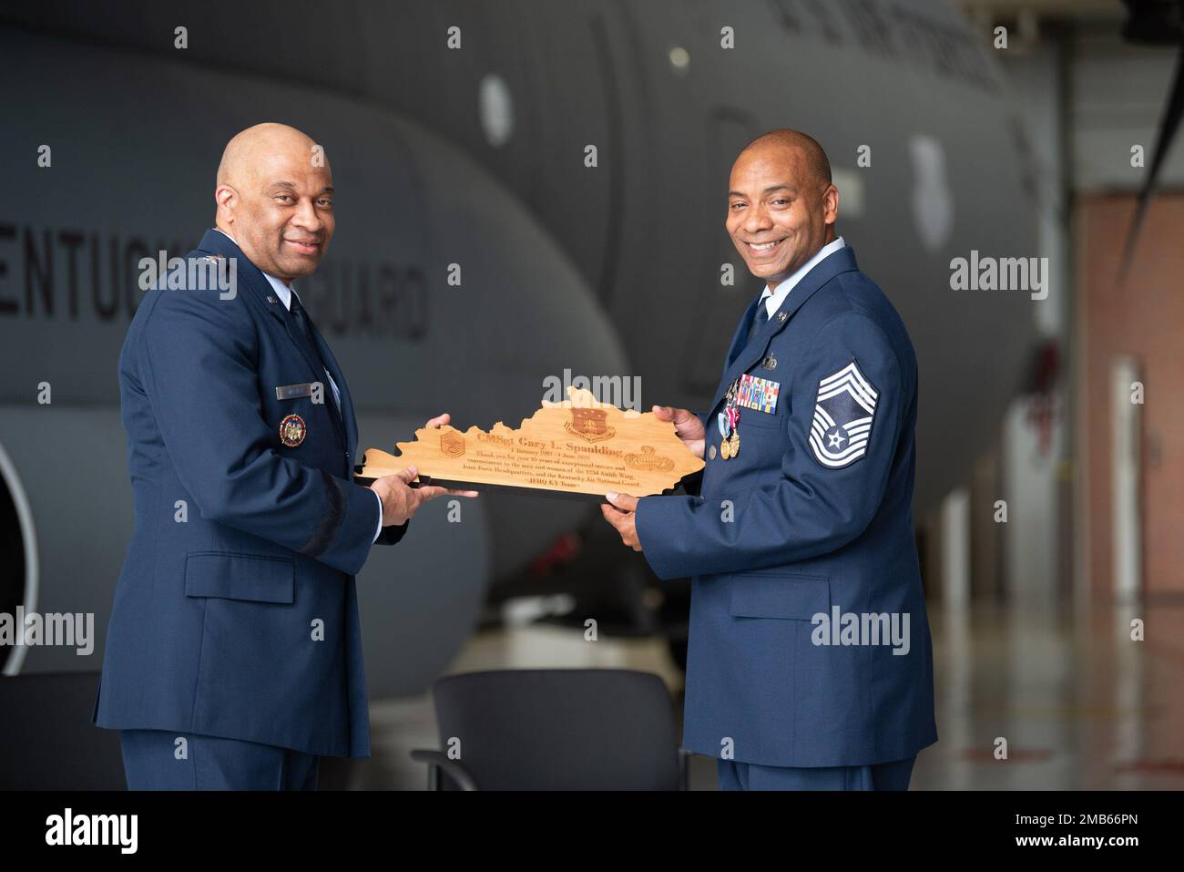 Chief Master Sgt. Gary L. Spaulding, right, military personnel management officer for the Kentucky Air National Guard, receives a plaque from  Maj. Gen. Charles M. Walker, director of the Office of Complex Investigations at the National Guard Bureau, during Spaulding’s retirement ceremony at the Kentucky Air National Guard Base in Louisville, Ky., June 12, 2022. Spaulding served 35 in the Kentucky Air Guard. Stock Photo