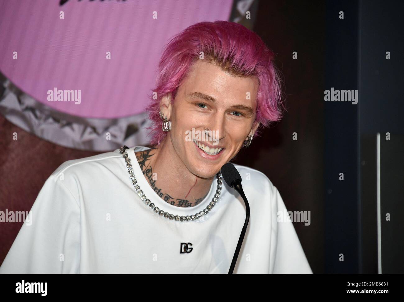 Machine Gun Kelly participates in a ceremonial lighting of the Empire