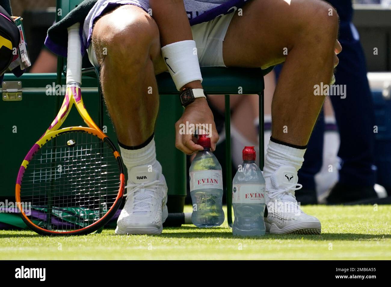 Spains Rafael Nadal arranges his water bottles during a break in his match against Argentinas Francisco Cerundolo in a first round mens singles match on day two of the Wimbledon tennis championships