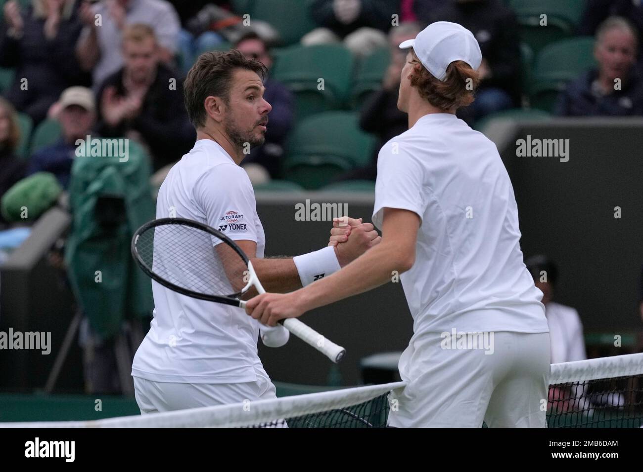 Italys Jannik Sinner, right, shakes hands with Switzerlands Stan Wawrinka after defeating him in their mens singles match on day one of the Wimbledon tennis championships in London, Monday, June 27, 2022