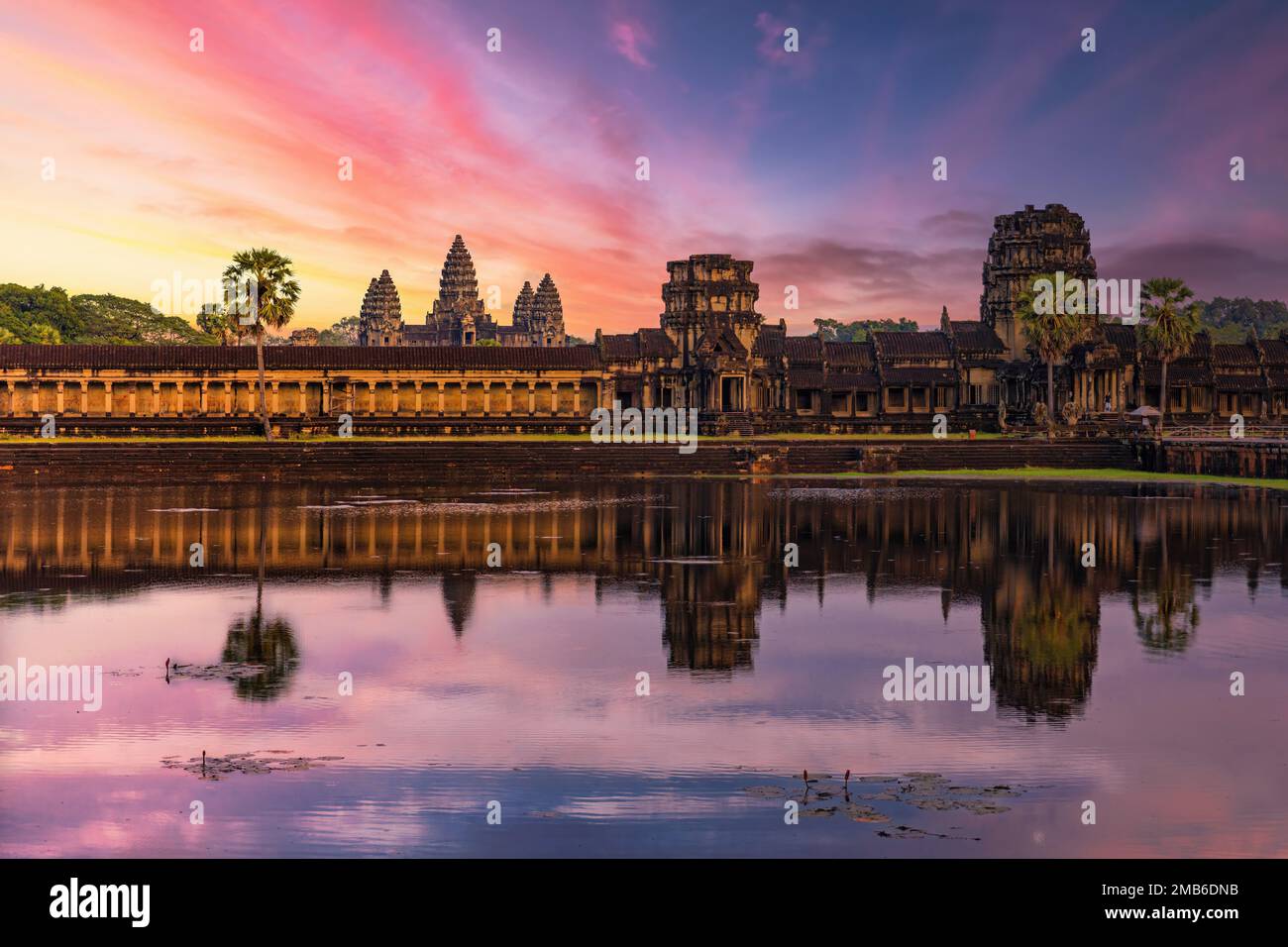 Angkor Wat temple reflecting in water of Lotus pond at sunset Stock Photo
